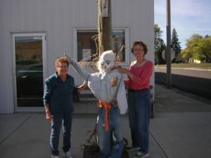 Marceline Hoaglund & Shirley Nitz decorating scarecrow.