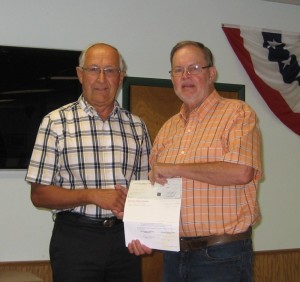 Ron Carwright, right, accepting Senior Center grant from Joe Weninger