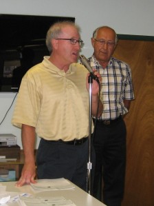 Steve Heim, left, accepting Little Raider's grant from Joe Weninger
